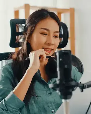 Radio host at desk with microphone and notes – user engagement & CastHost internet-radio hosting